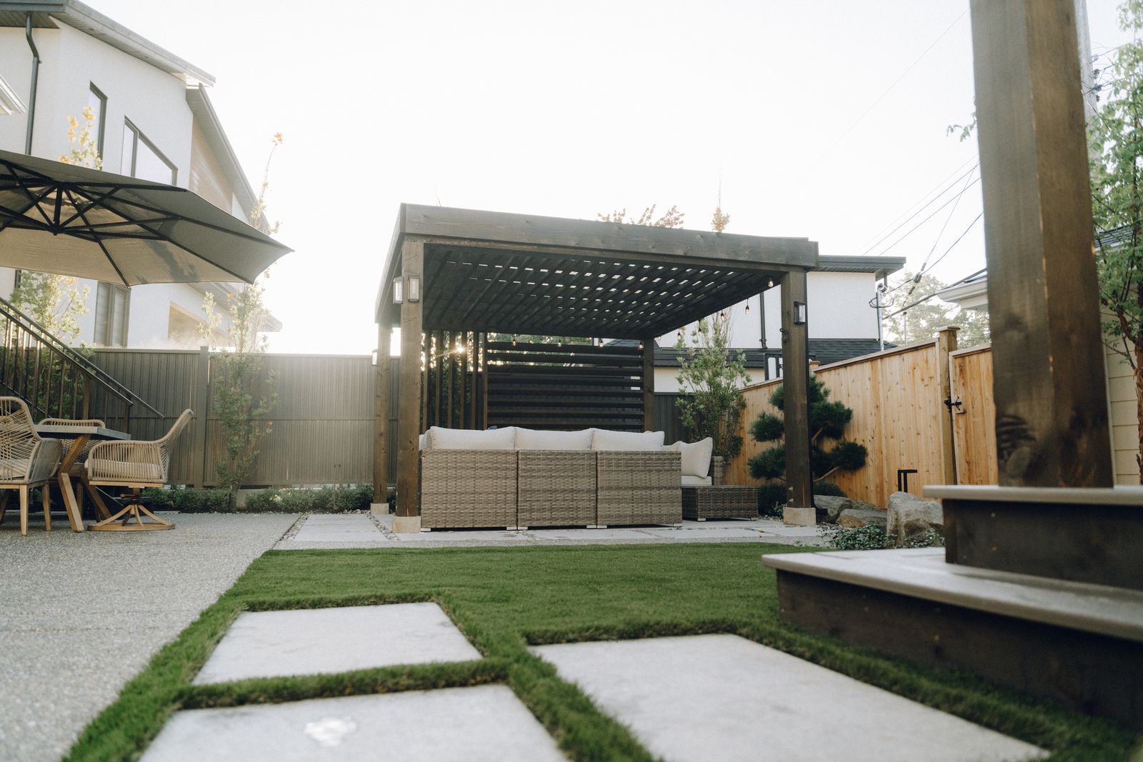 Full backyard with a pergola lounge, turf and concrete pads
