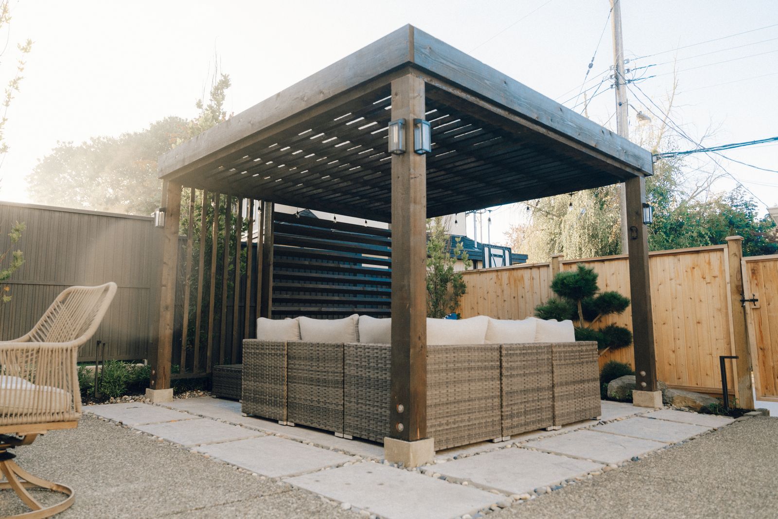 Steel and cedar pergola over an outdoor lounge